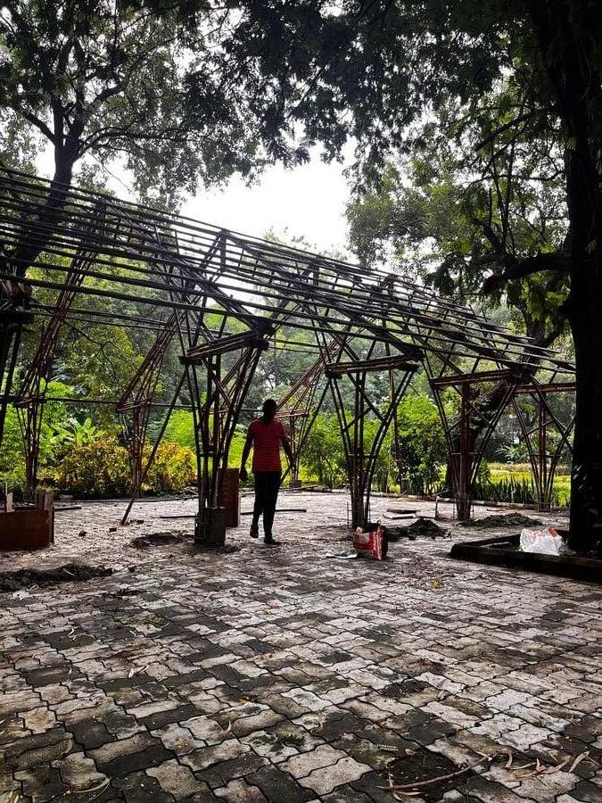 Assembly — bamboo columns and beam frame being erected on site