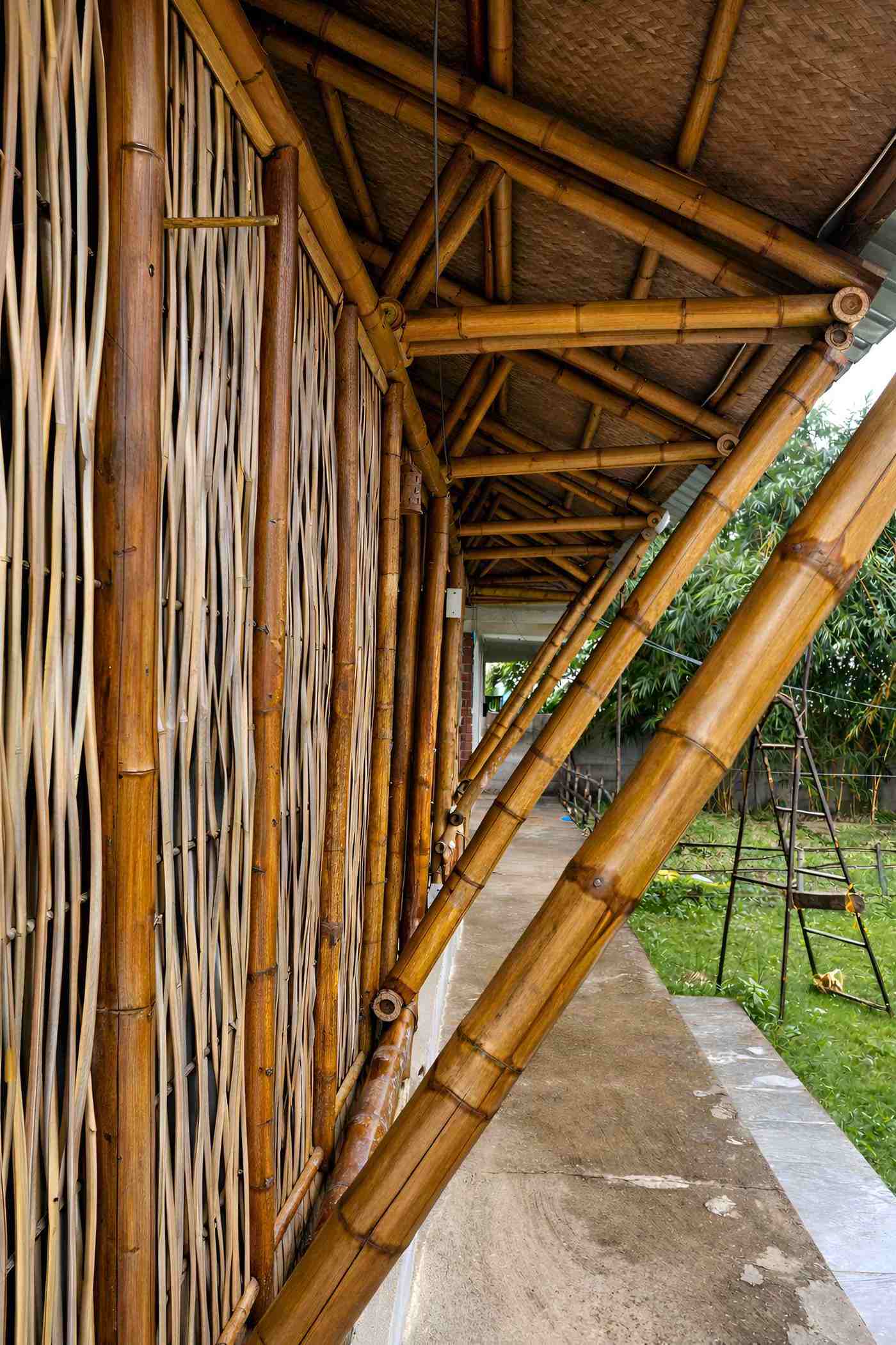 Conference hall side elevation — bamboo wall cladding and entrance approach